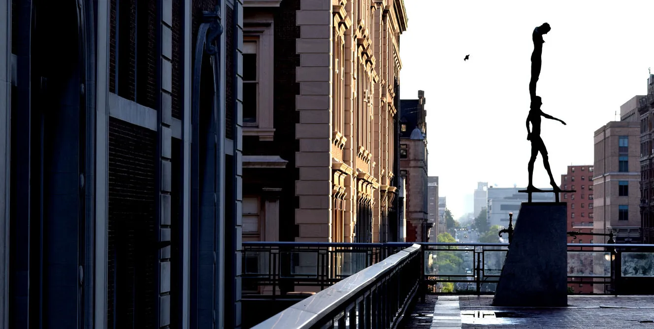 sculpture on bridge with evening light
